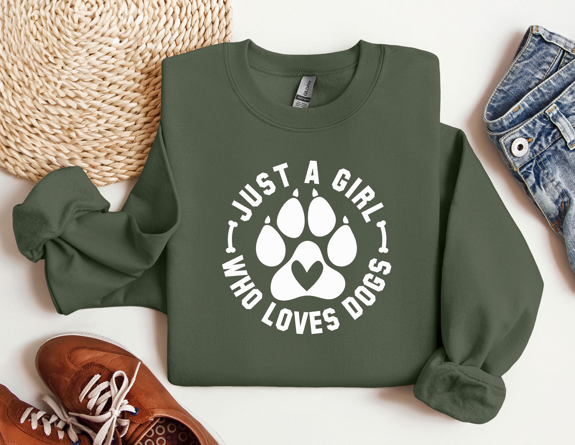 a green sweatshirt with a white dog paw on it