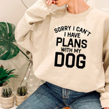 a woman wearing a sweatshirt that says sorry i can't i have plans with