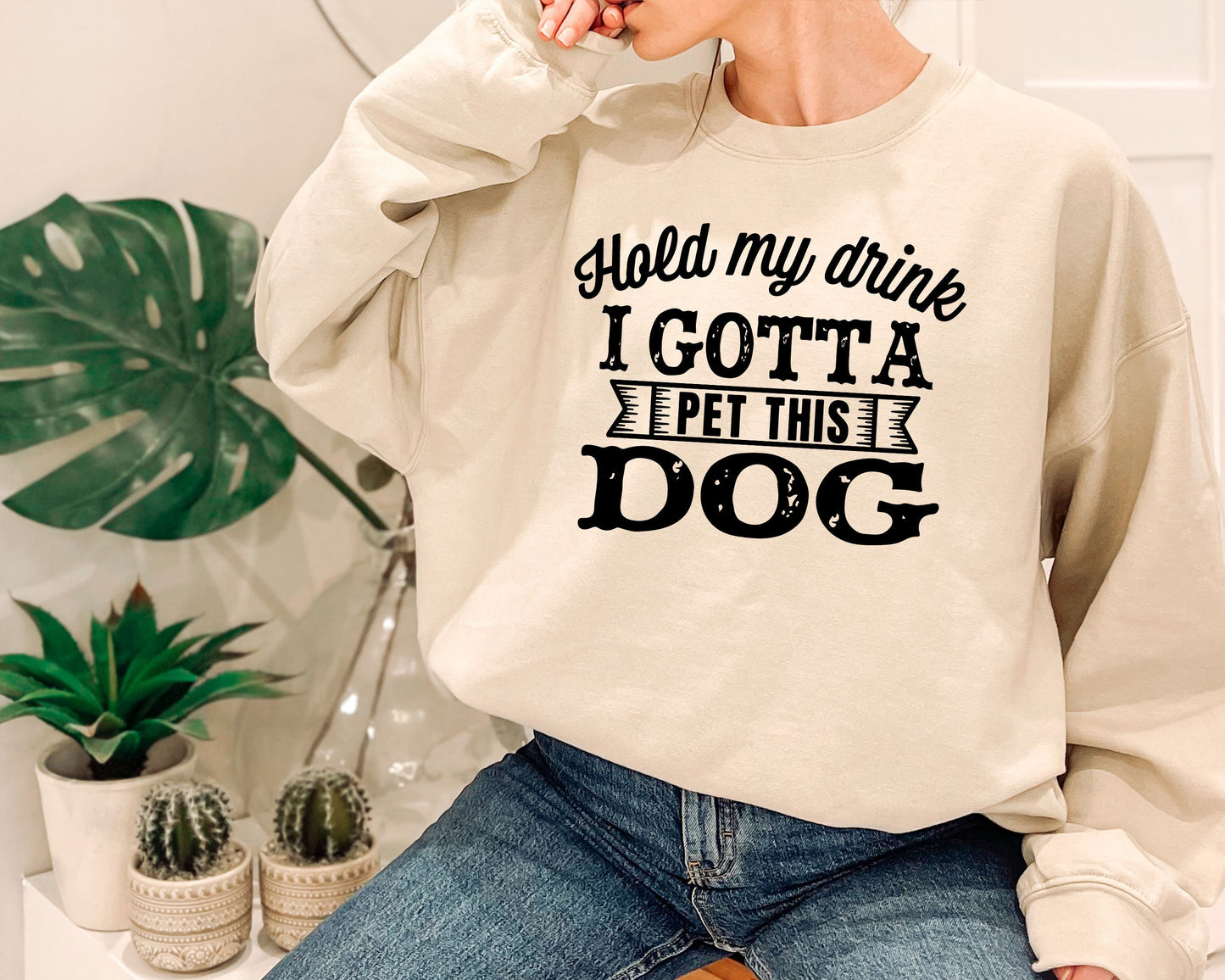 a woman wearing a sweatshirt that says, i gota pet this dog