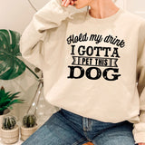 a woman wearing a sweatshirt that says, i gota pet this dog