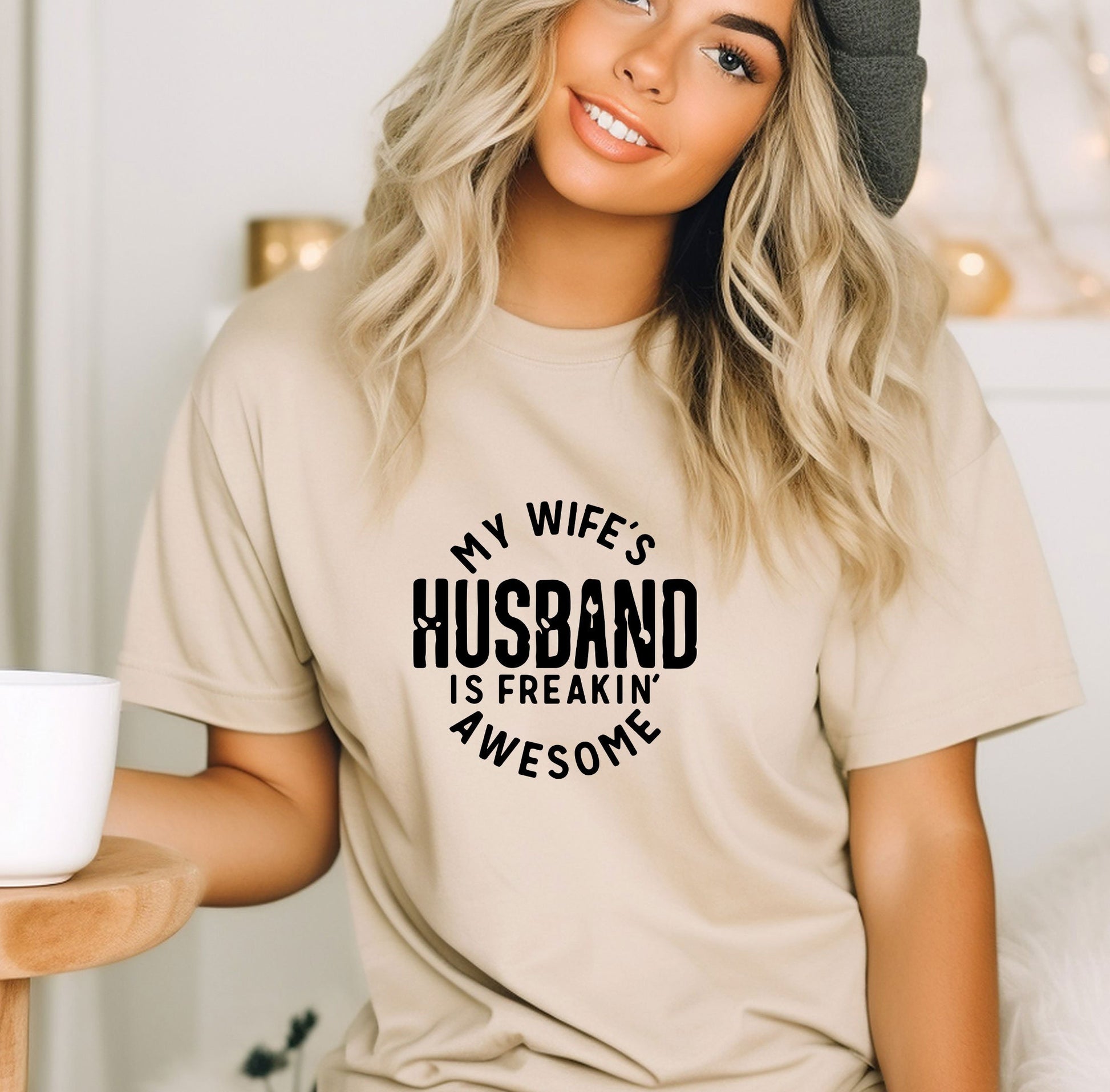 a woman wearing a t - shirt that says, my wife&#39;s husband is