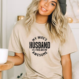 a woman wearing a t - shirt that says, my wife's husband is