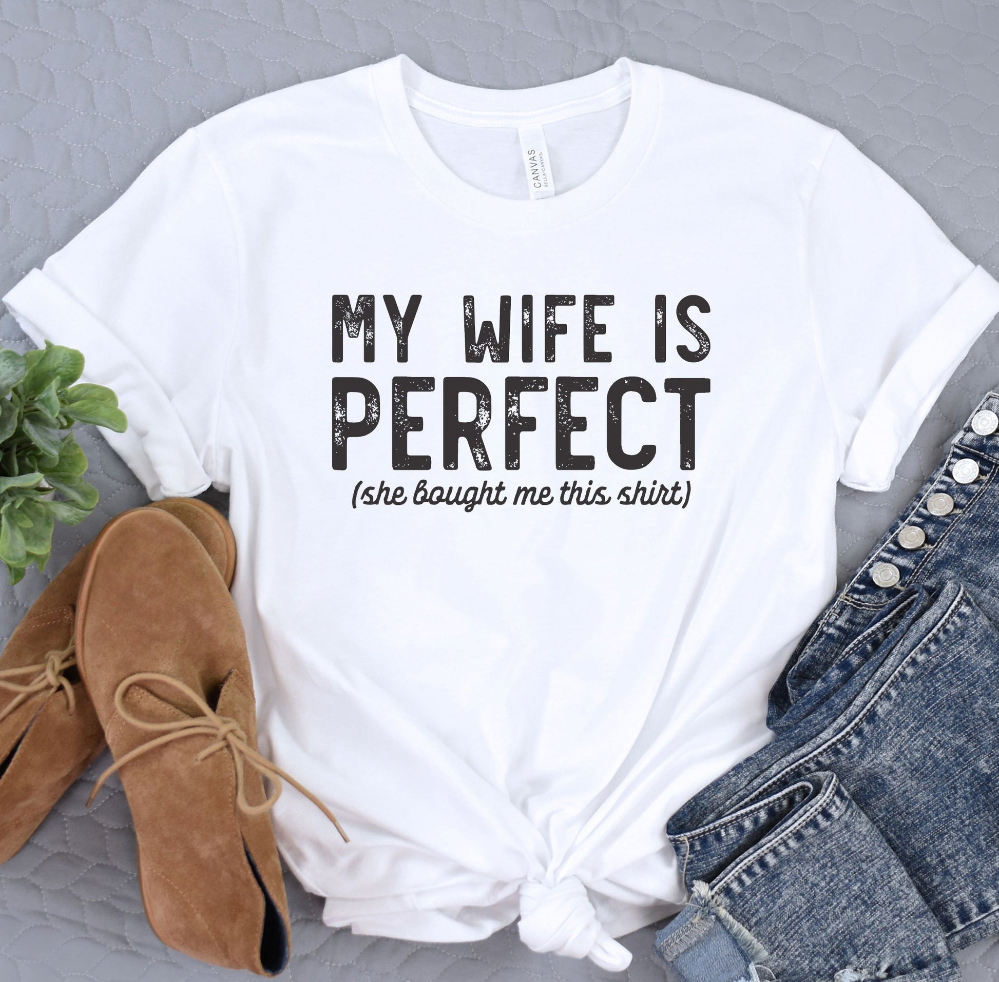a white t - shirt that says, my wife is perfect she taught me this