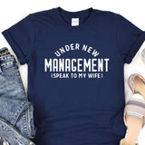 a t - shirt that says under new management speak to my wife