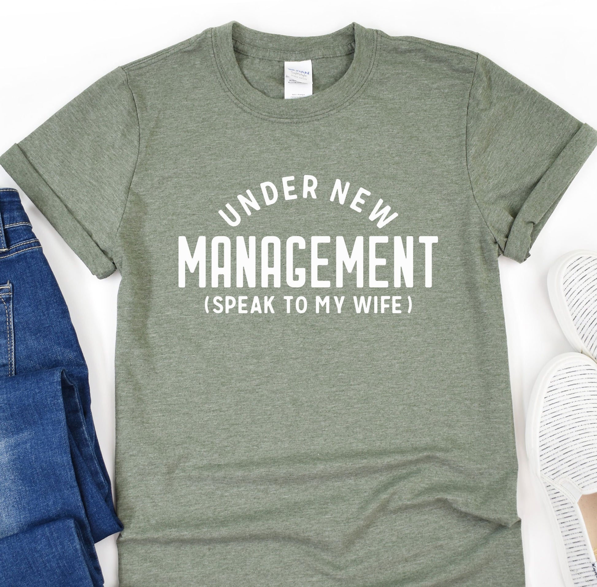 a t - shirt that says under new management speak to my wife