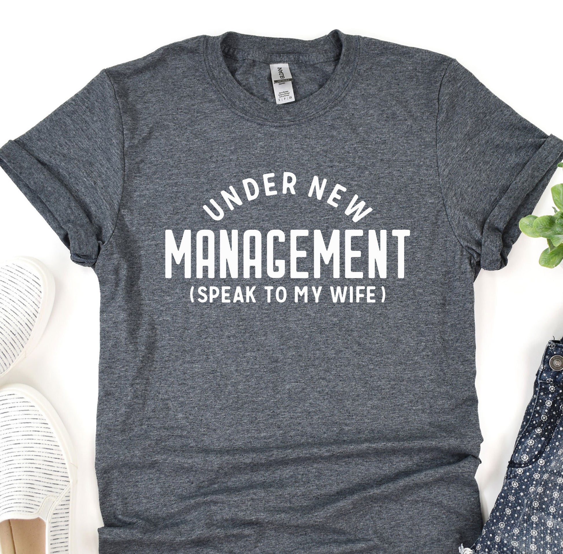 a t - shirt that says under new management speak to my wife