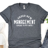 a t - shirt that says under new management speak to my wife