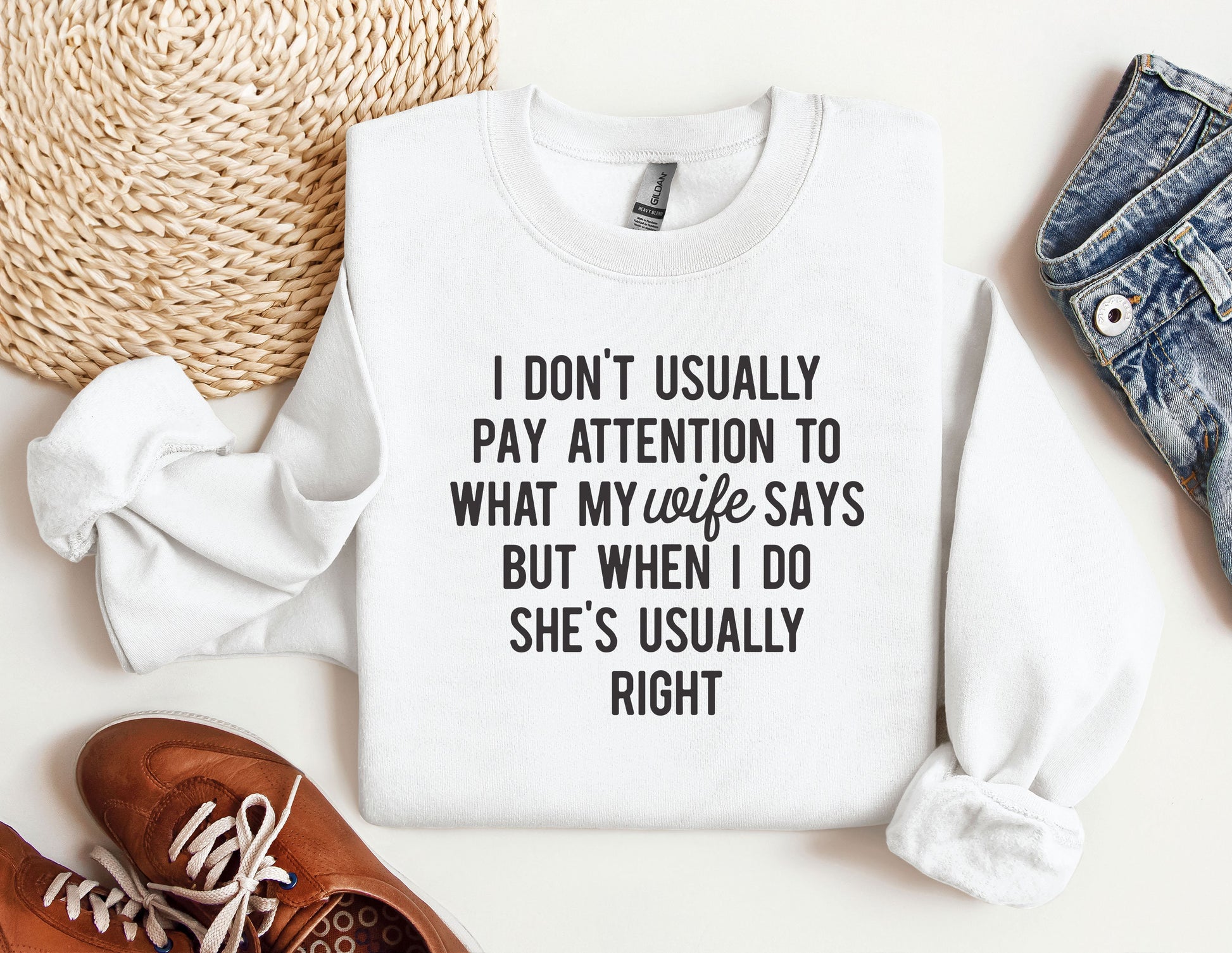 a sweater with a quote on it next to a pair of shoes