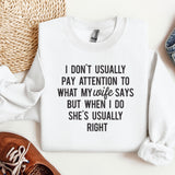 a sweater with a quote on it next to a pair of shoes