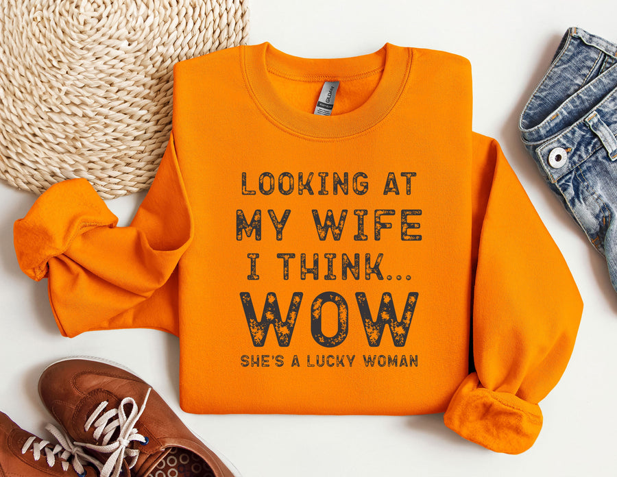 an orange shirt that says looking at my wife i think wow she's a