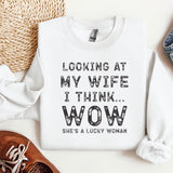 a sweater that says looking at my wife i think wow she's a lucky