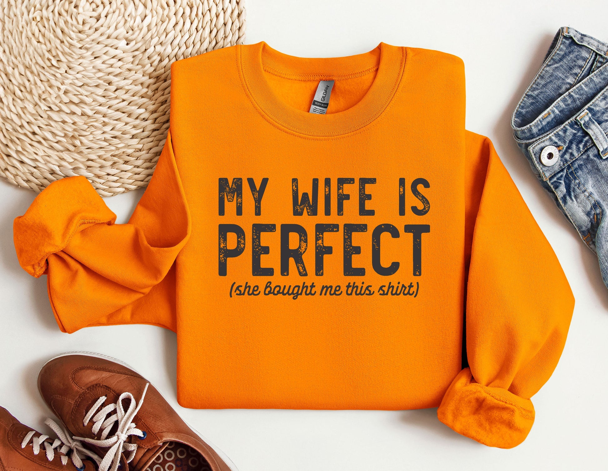 a pair of shoes and an orange sweatshirt with the words my wife is perfect