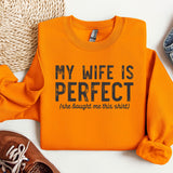 a pair of shoes and an orange sweatshirt with the words my wife is perfect