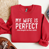 a red sweatshirt that says, my wife is perfect she bought me this shirt