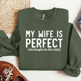 a green sweatshirt that says, my wife is perfect, and a pair of shoes