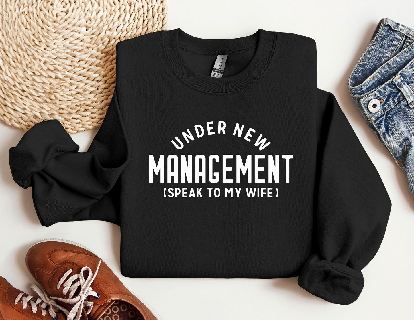 a black sweater that says under new management i speak to my wife