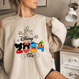 a woman wearing a sweatshirt with mickey mouse on it