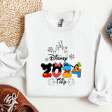 a mickey mouse shirt and some shoes on a table