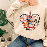 a woman sitting on a chair wearing a disney sweatshirt