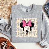a mickey mouse sweatshirt with a pink bow on it