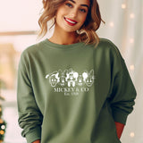 a woman wearing a green mickey mouse sweatshirt