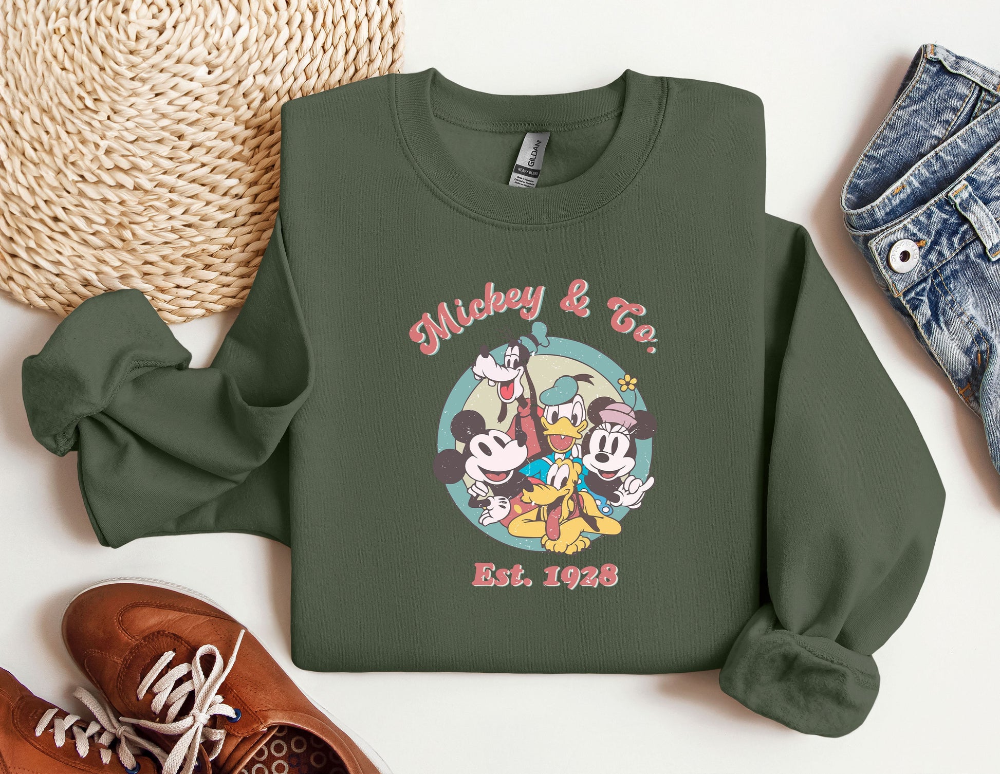 a green sweatshirt with mickey and friends on it