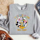 a mickey mouse shirt next to a pair of shoes