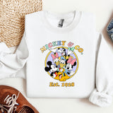 a mickey mouse shirt next to a pair of shoes
