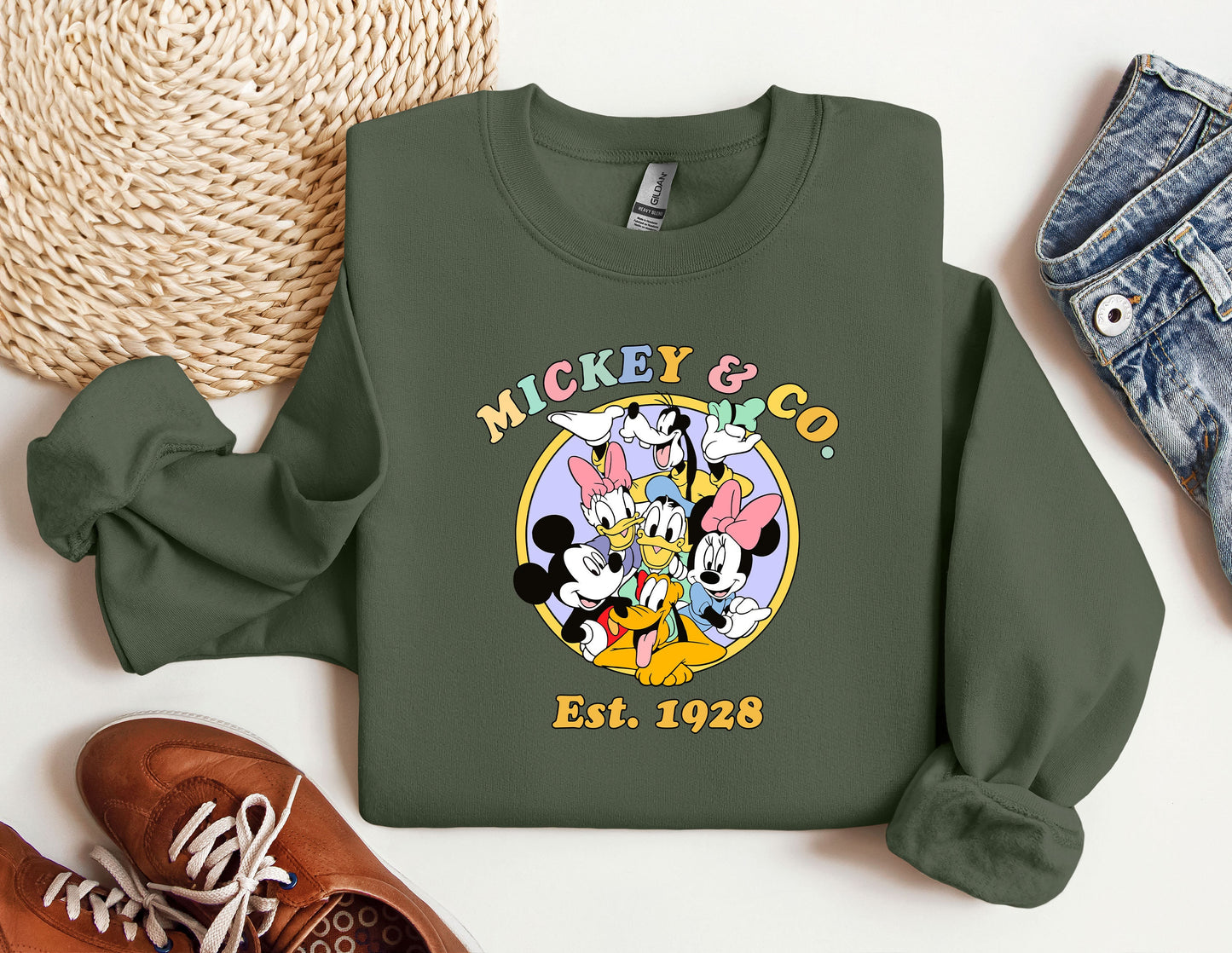 a mickey mouse and friends shirt next to a pair of sneakers