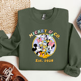 a mickey mouse and friends shirt next to a pair of sneakers