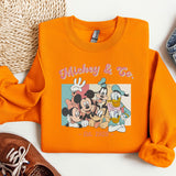 a pair of shoes and an orange mickey mouse shirt