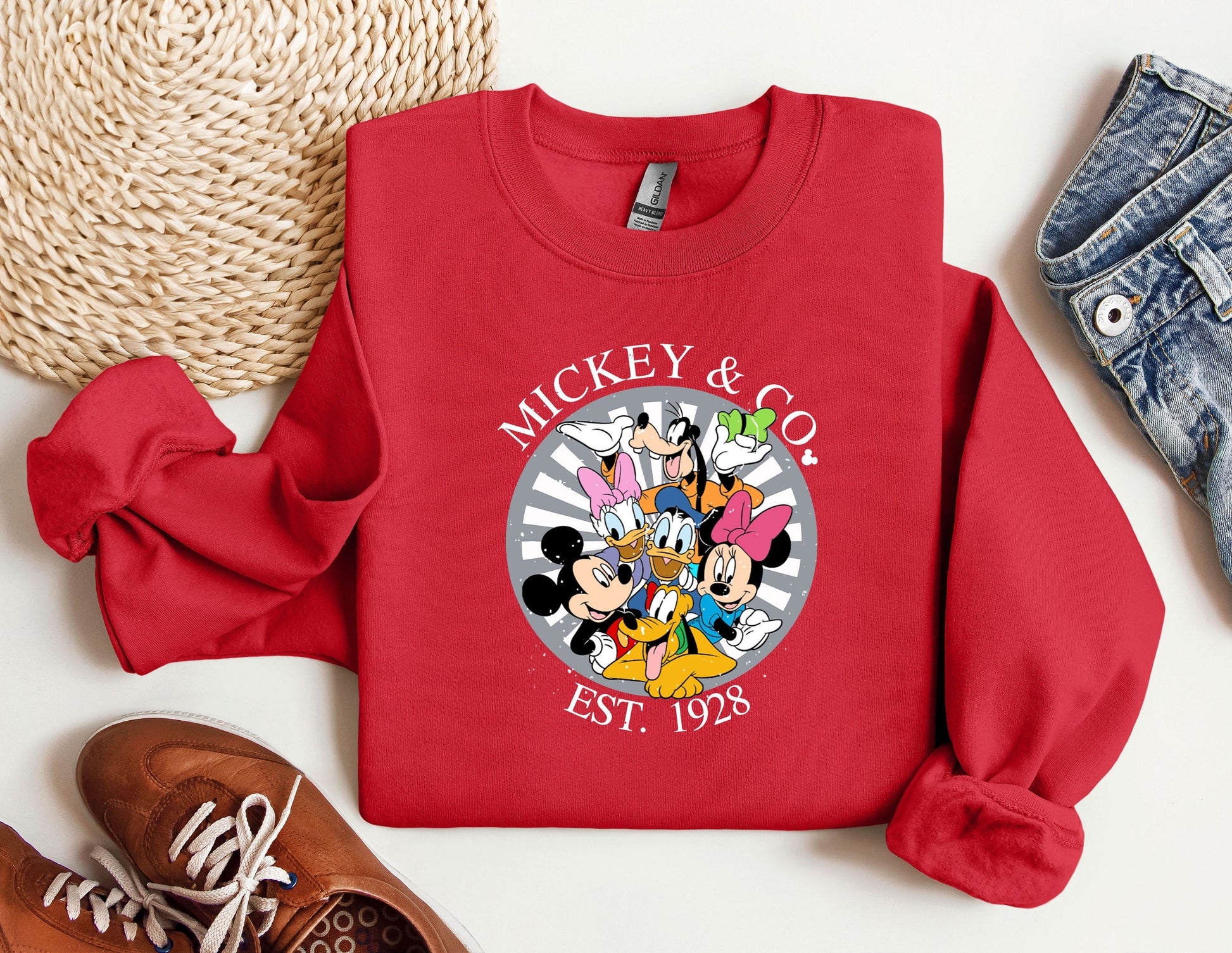 a mickey and mickey mouse shirt next to a pair of sneakers