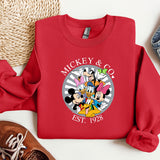 a mickey and mickey mouse shirt next to a pair of sneakers