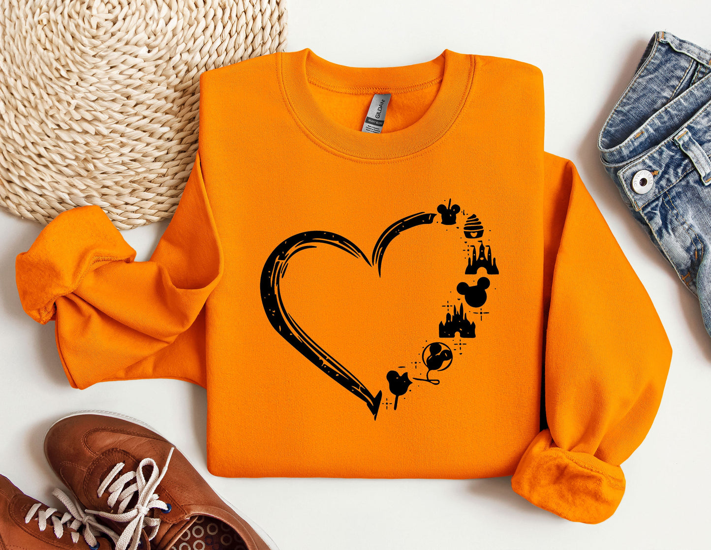 an orange shirt with a heart and paw prints on it