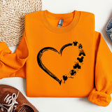 an orange shirt with a heart and paw prints on it