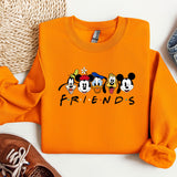 a pair of sneakers and a sweatshirt with mickey mouses on it