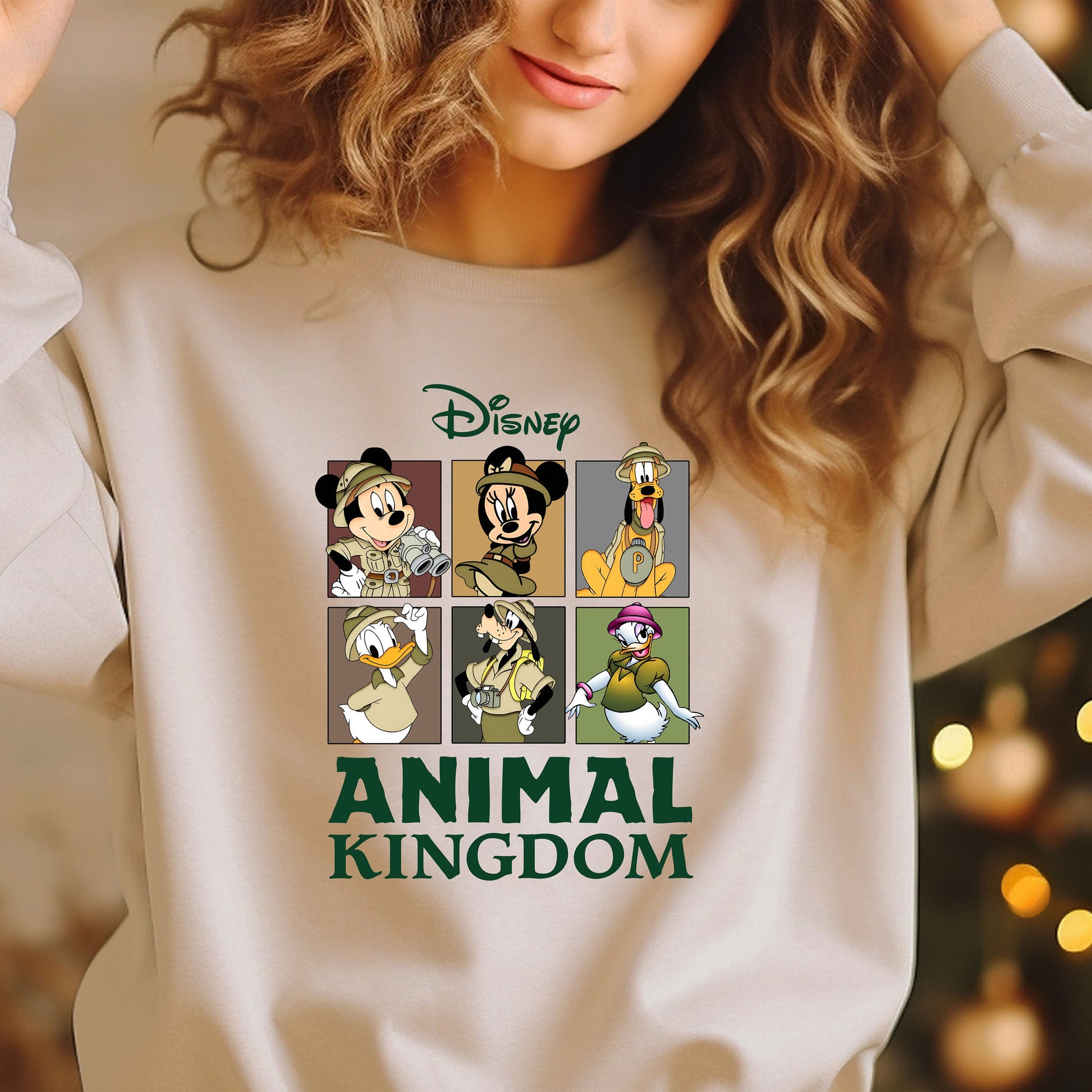 a woman wearing a sweatshirt that says animal kingdom