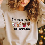 a woman wearing a sweatshirt that says i'm here for the snacks
