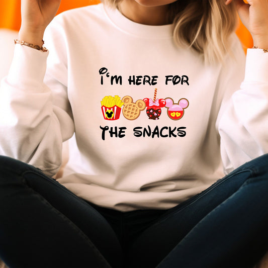 a woman sitting on the floor wearing a white sweatshirt