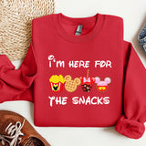 a red sweatshirt with the words i'm here for the snacks printed on it