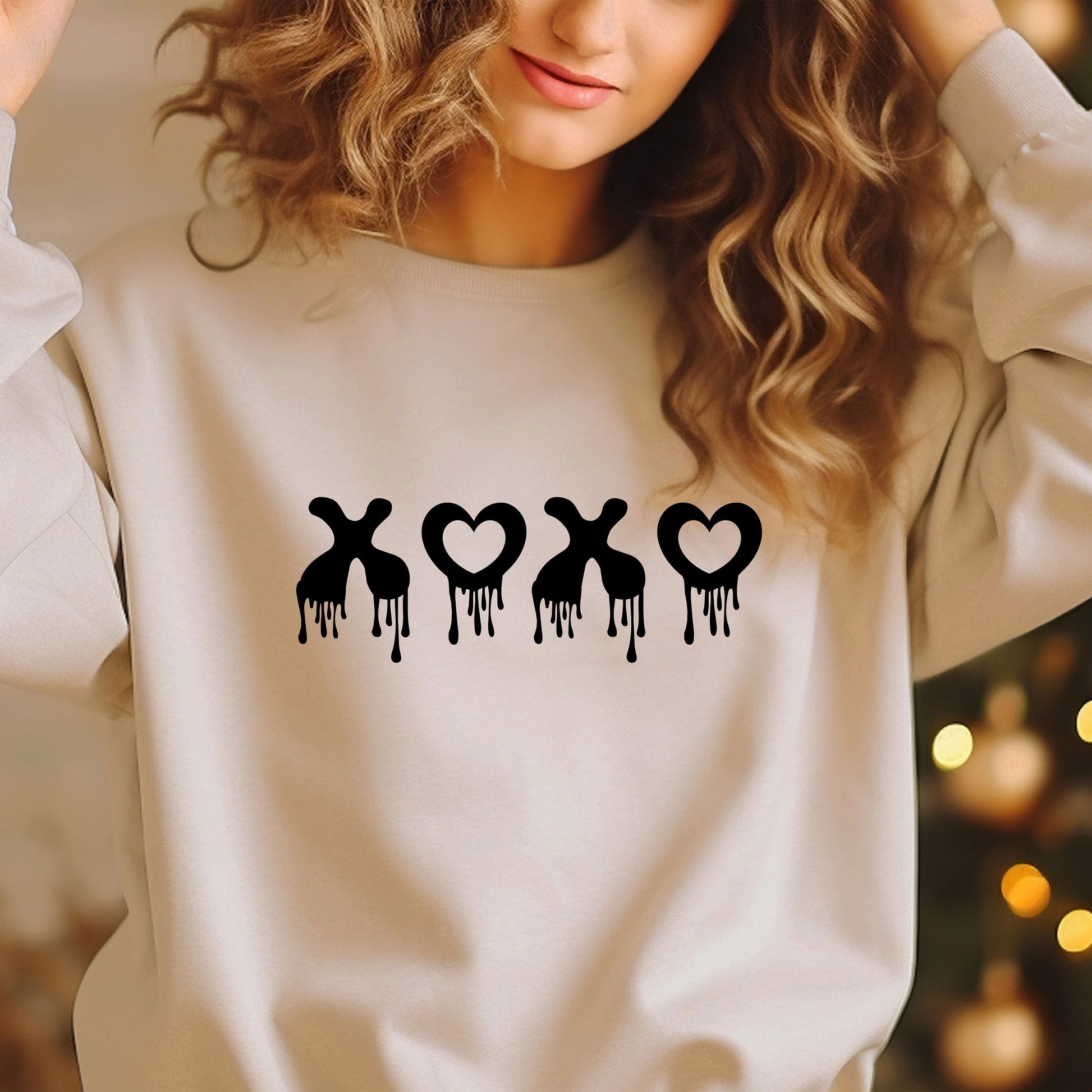 a woman wearing a sweatshirt with the word x on it