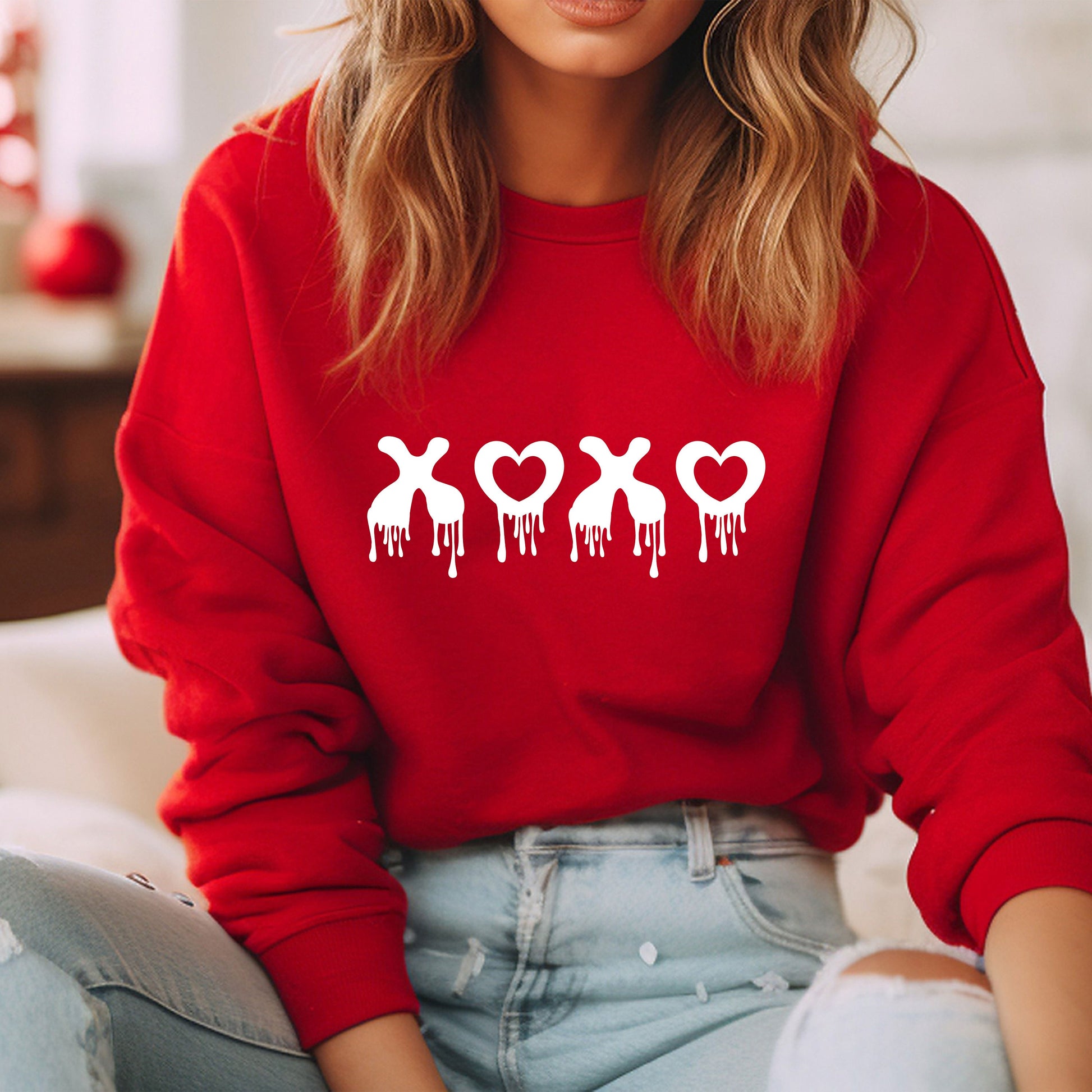 a woman wearing a red sweatshirt with the word love on it