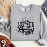 a sweater with a hand holding a knife on it
