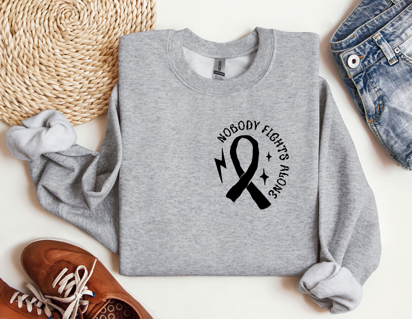 a gray sweatshirt with a black ribbon on it