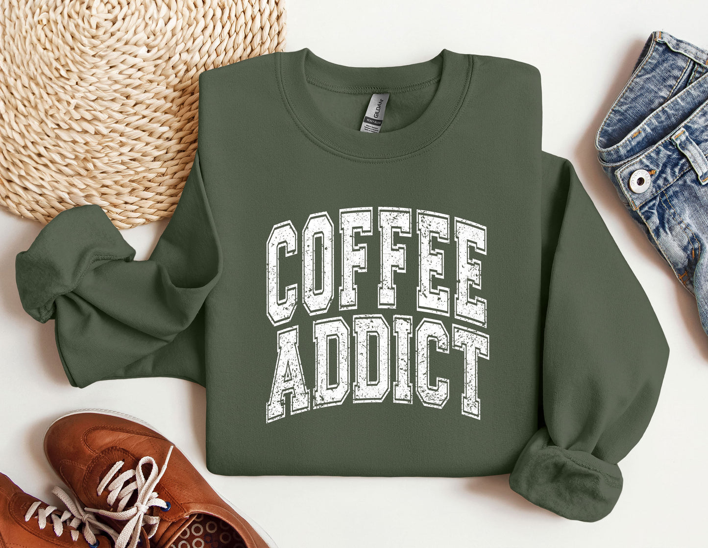 a sweatshirt that says coffee addict next to a pair of sneakers