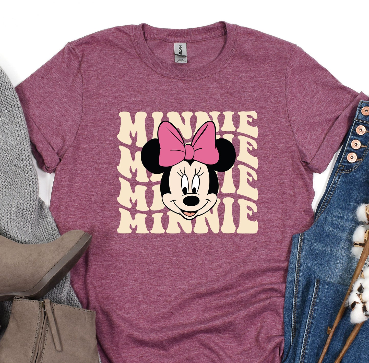 a minnie mouse shirt with a pink bow on it