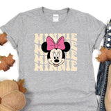 a minnie mouse shirt with a pink bow on it