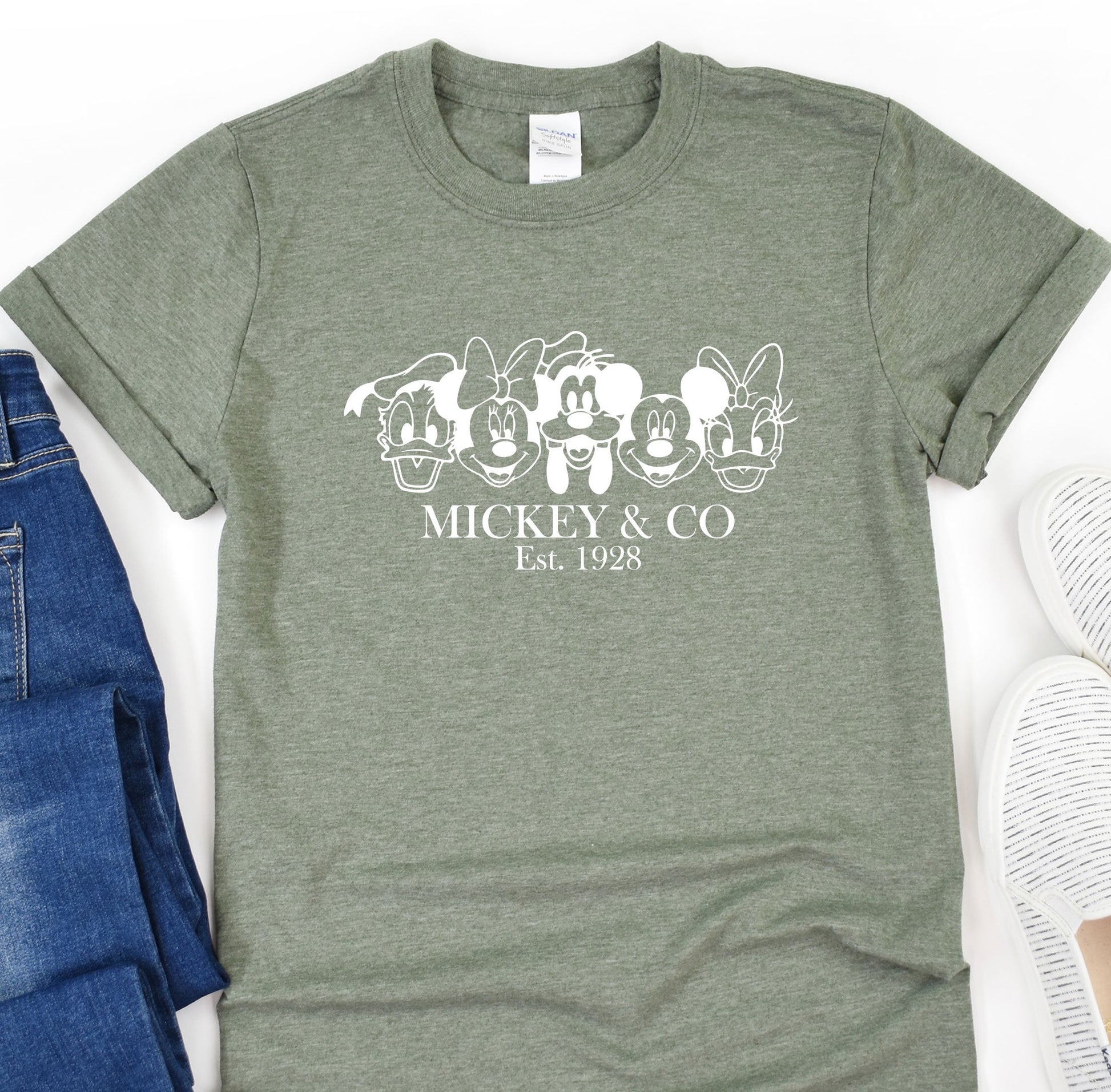 a mickey and mickey mouse t - shirt next to a pair of jeans