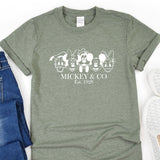 a mickey and mickey mouse t - shirt next to a pair of jeans