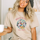a woman wearing a mickey and minnie mouse t - shirt
